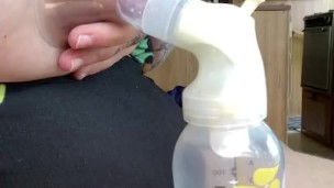 Milkymama in a bathing suit pumps milk filled tits while camping